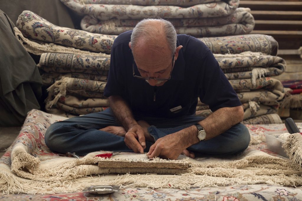 old man, carpet repair, iranian carpet-7317434.jpg